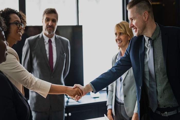 conflict of interest office people shaking hands